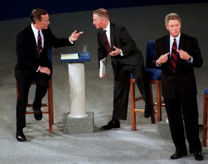 FILE - In this Oct. 15, 1992 file photo, President Bush, left, talks with independent candidate Ross Perot as Democratic candidate Bill Clinton stands aside at the end of their second presidential debate in Richmond, Va.   (AP Photo/Marcy Nighswander, File) 